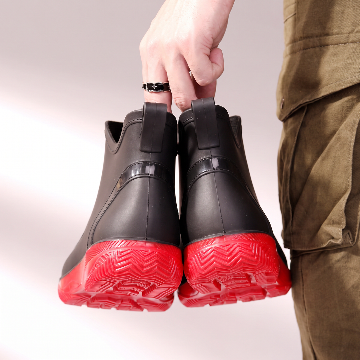 Schwarze Gummistiefel mit roter Sohle und Zuglasche, Rückansicht